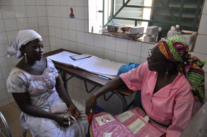 A photo of a health professional providing a female with a reproductive health consultation.