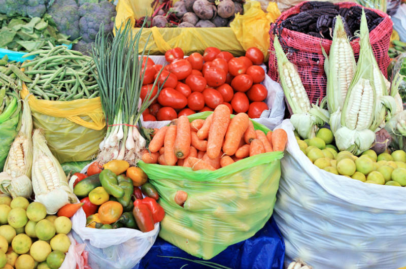 Bushels of vegetables and fruit in a market.